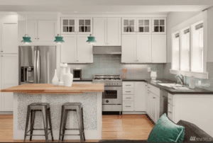 Bright modern kitchen with white cabinets, island, and ample natural light.