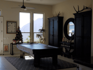 Elegant living space featuring a pool table, large windows, and decorative accents.